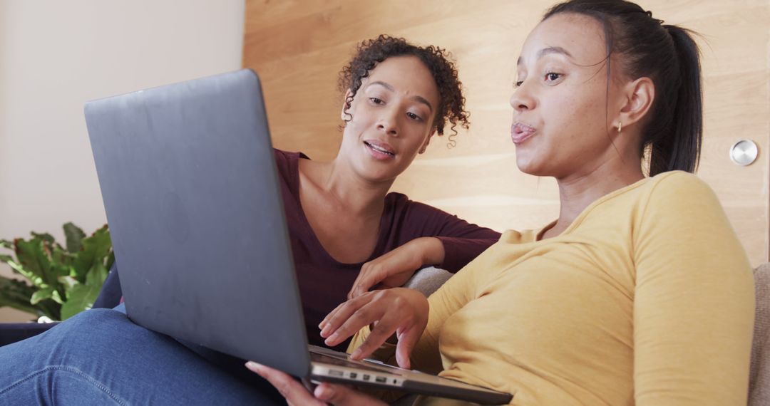 Two Women Collaborating on Laptop in Home Office Setting - Free Images, Stock Photos and Pictures on Pikwizard.com