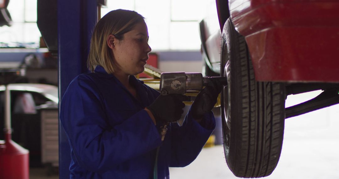 Female Mechanic Fixing Car in Auto Repair Shop - Free Images, Stock Photos and Pictures on Pikwizard.com