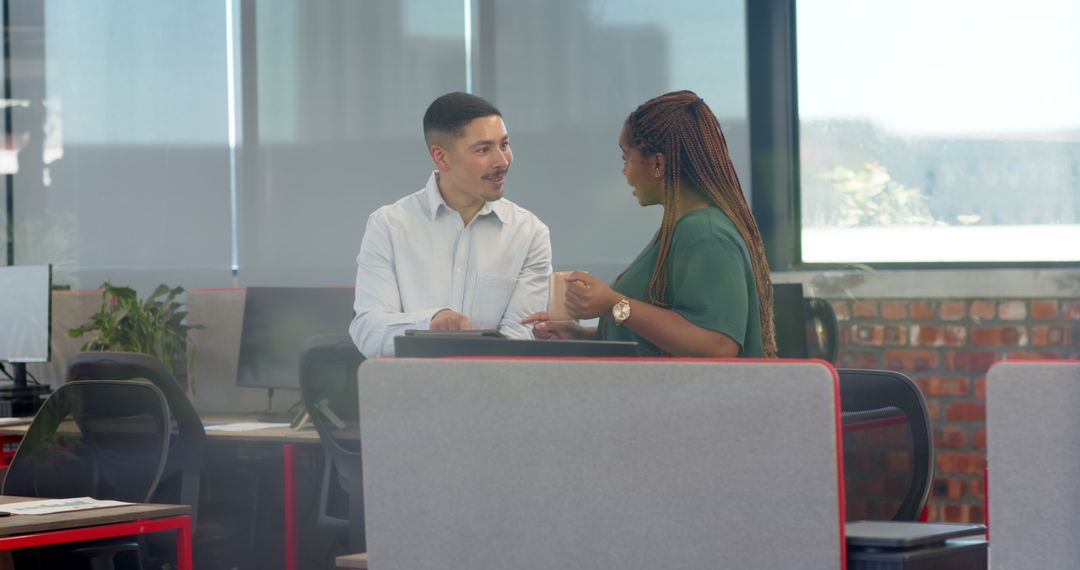 Colleagues Engaging in Empowering Office Discussion with Tablet