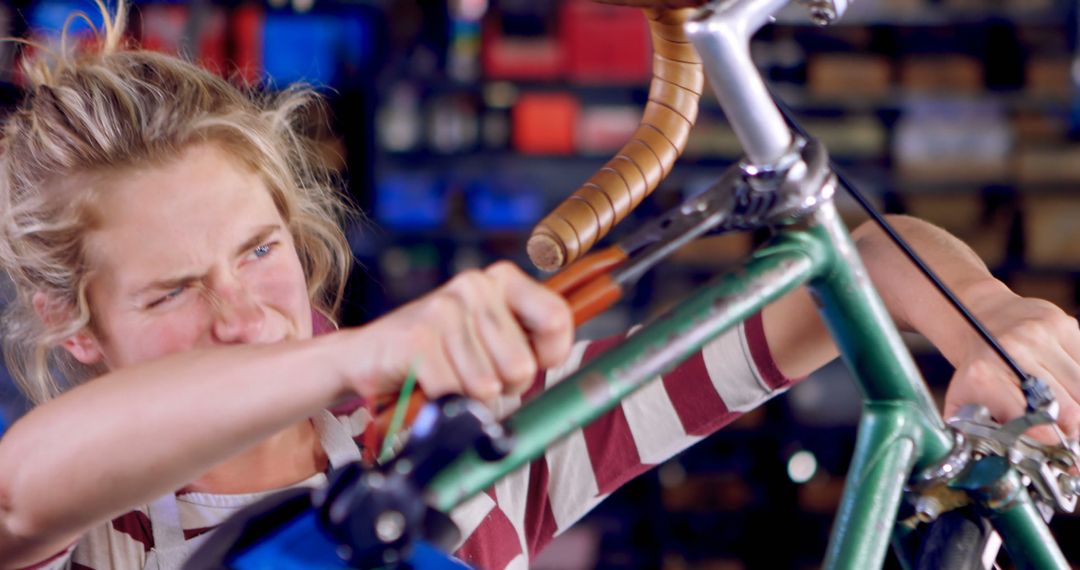 Focused Female Mechanic Adjusting Bicycle Handlebars in Workshop - Free Images, Stock Photos and Pictures on Pikwizard.com