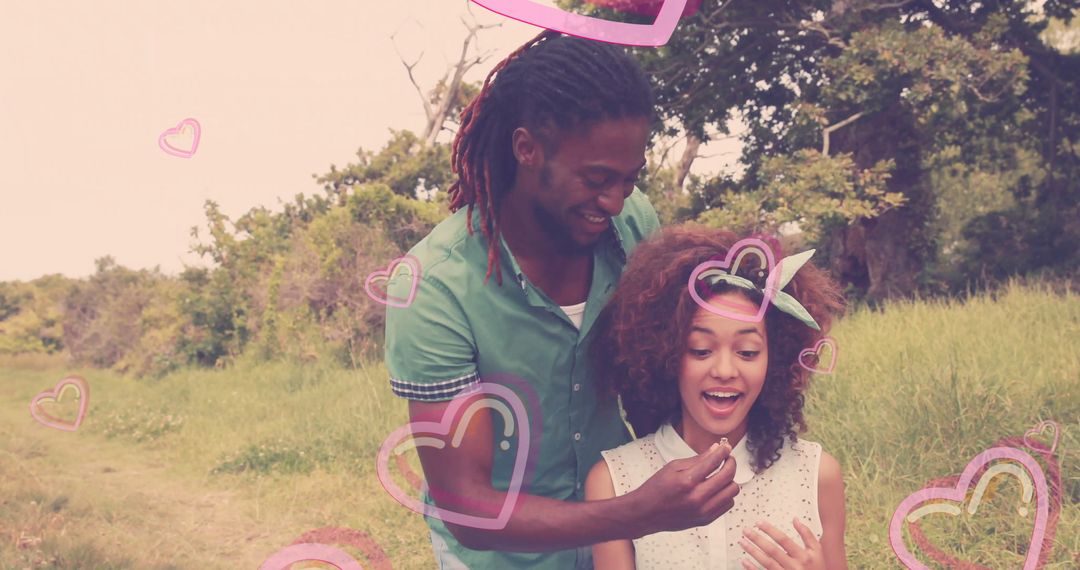 Romantic Couple Bonding Surrounded by Heart Graphics in Green Meadow