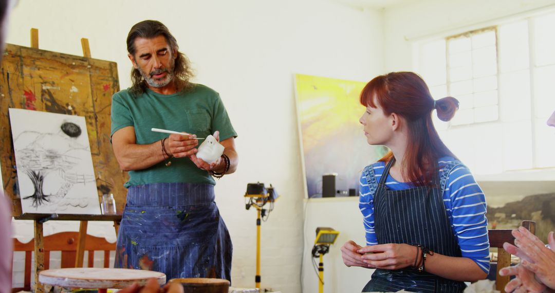 Art Instructor Teaching Pottery to Students in Studio - Free Images, Stock Photos and Pictures on Pikwizard.com