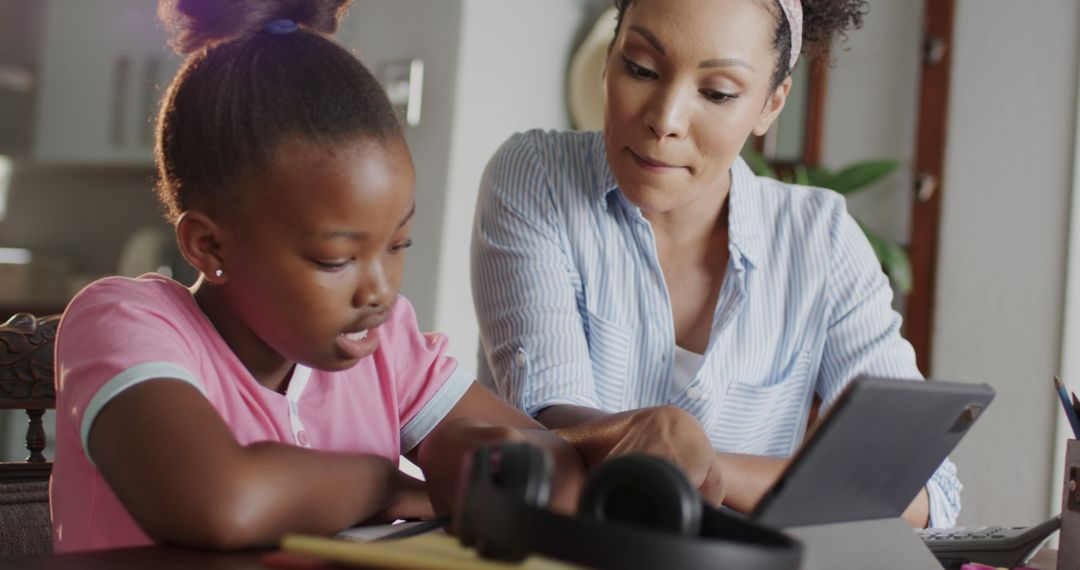 African American Mother Helping Daughter with Homework at Home - Free Images, Stock Photos and Pictures on Pikwizard.com