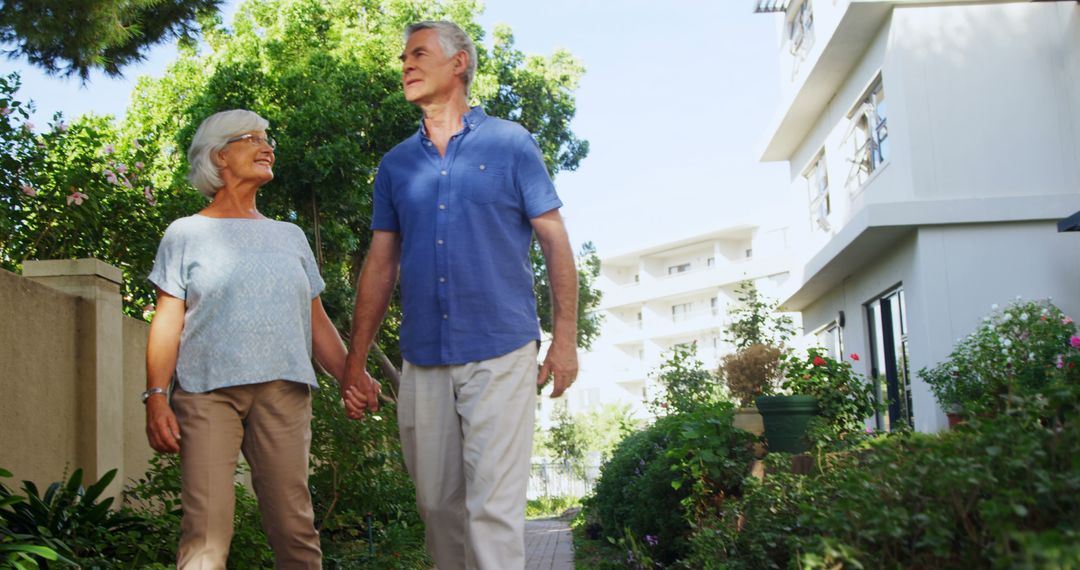 A senior couple happily strolls through a sunny neighborhood, embodying contentment. - Free Images, Stock Photos and Pictures on Pikwizard.com
