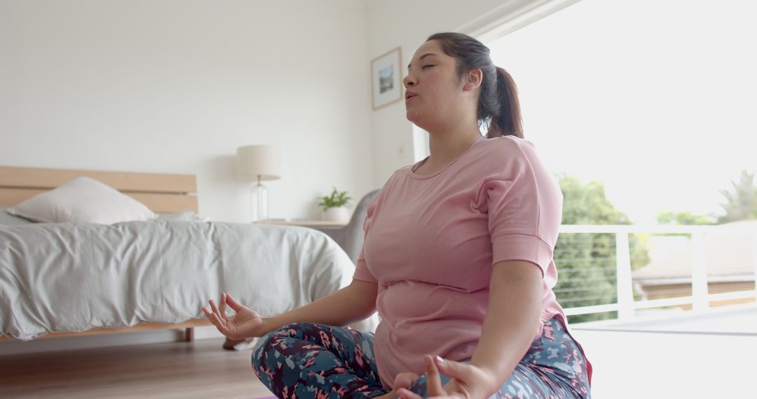 Plus Size Woman Meditating in Relaxing Home Environment