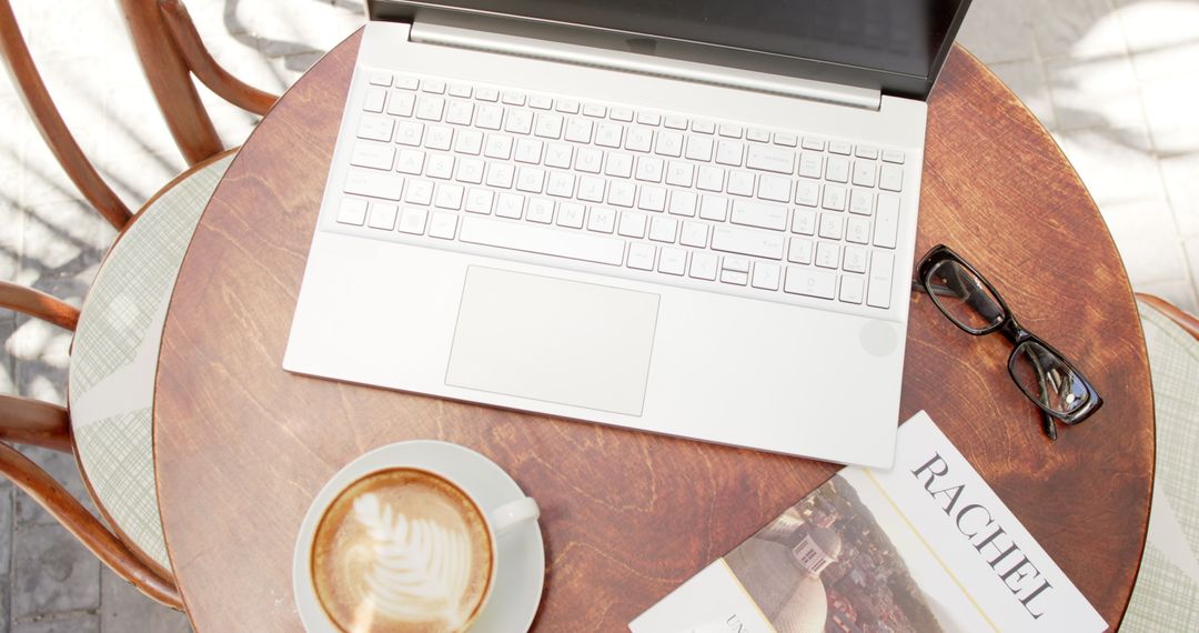 Cozy Cafe Workspace with Laptop and Coffee Atmosphere