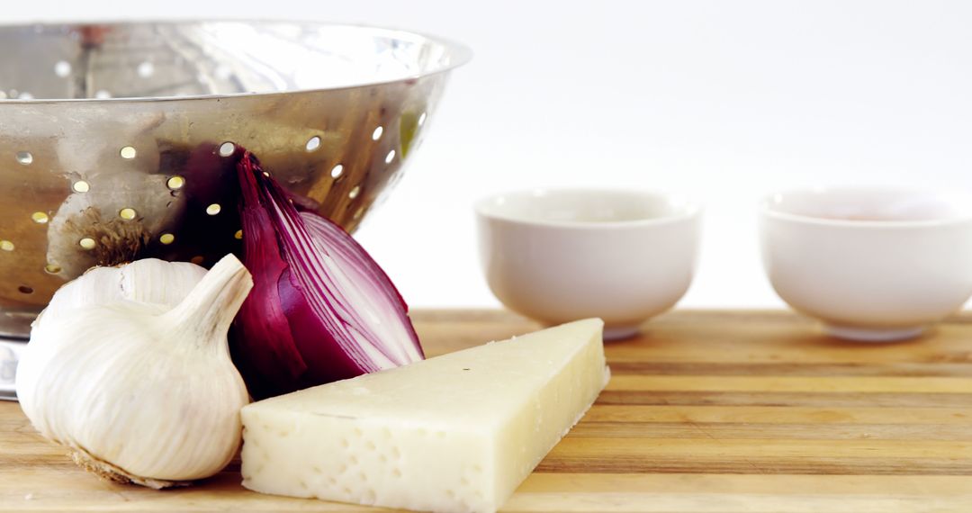 Garlic, Cheese, and Onion with Kitchen Utensils on Wooden Surface - Free Images, Stock Photos and Pictures on Pikwizard.com