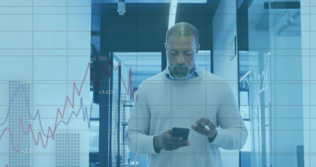 African American Businessman Analyzing Financial Graphs on Smartphone