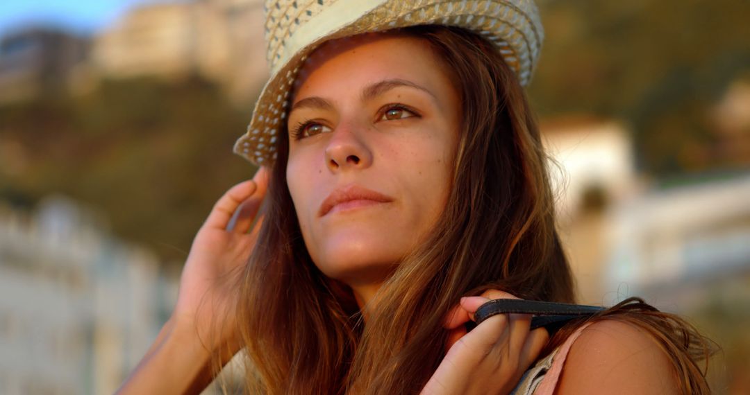 Young Woman with Hat Enjoying Sunset Outdoors - Free Images, Stock Photos and Pictures on Pikwizard.com