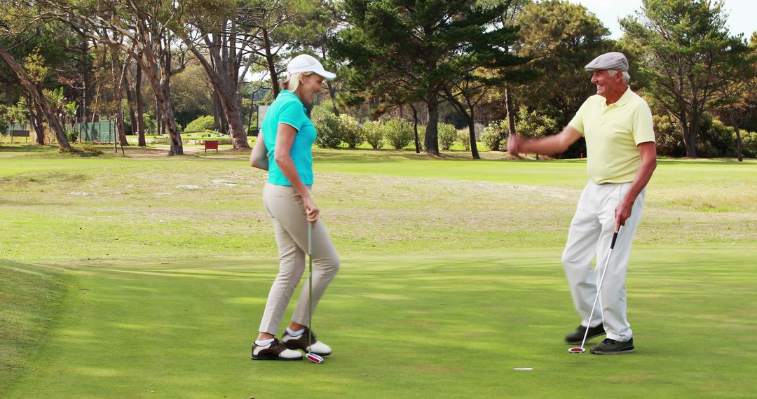 Senior Golfers Enjoying Game with High Five on Luxurious Golf Course