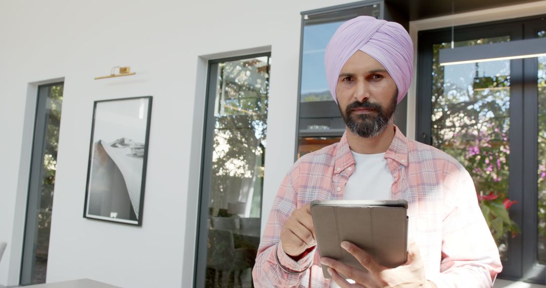 Man in Turban Using Tablet in Modern Home Interior