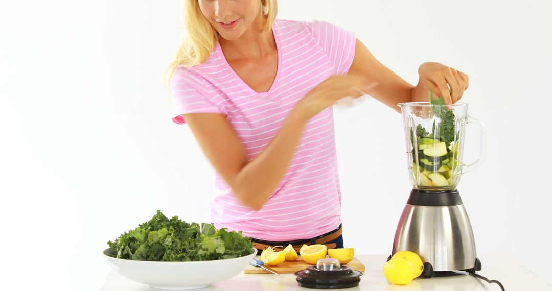 Woman Preparing Fresh Green Smoothie with Vegetables and Fruits - Free Images, Stock Photos and Pictures on Pikwizard.com