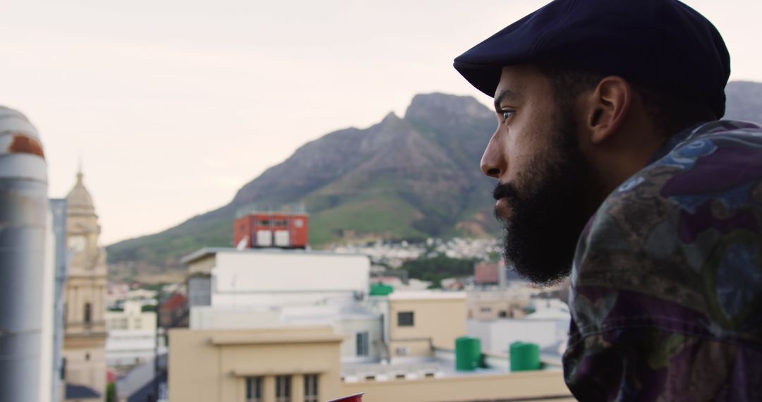 Man Relaxing on Rooftop with Mountain View