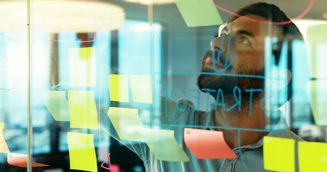 Focused Businessman Using Sticky Notes for Strategy Planning - Free Images, Stock Photos and Pictures on Pikwizard.com