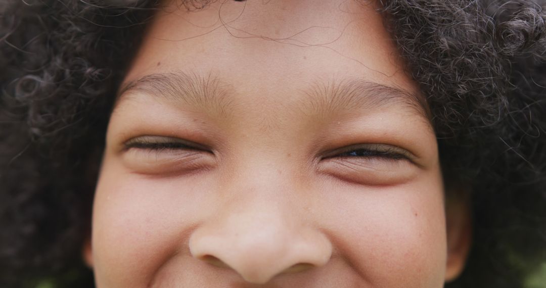 Close-up of Smiling Child with Curly Hair - Free Images, Stock Photos and Pictures on Pikwizard.com