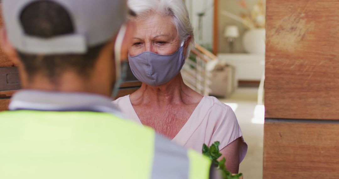 Senior Woman Receiving Delivery Wearing Mask - Free Images, Stock Photos and Pictures on Pikwizard.com