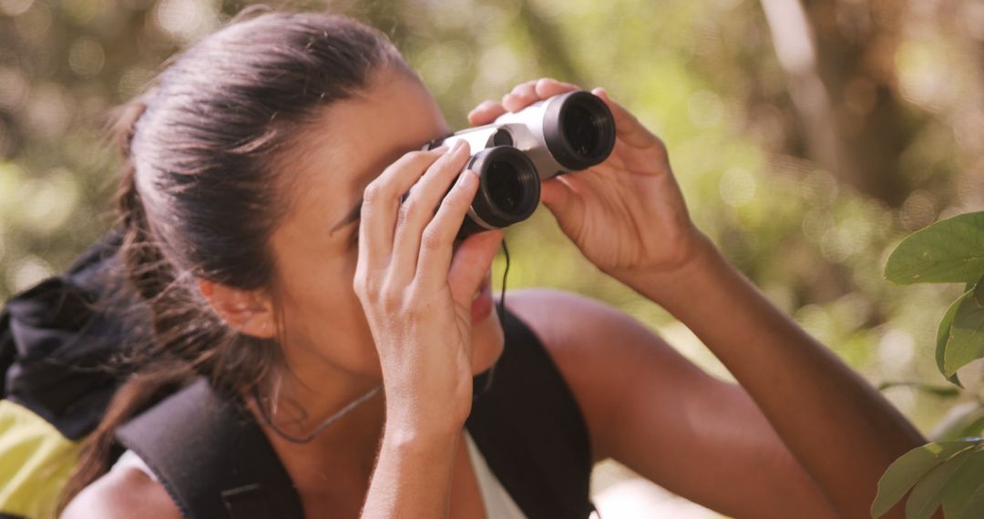 Young Woman Birdwatching with Binoculars in Forest - Free Images, Stock Photos and Pictures on Pikwizard.com