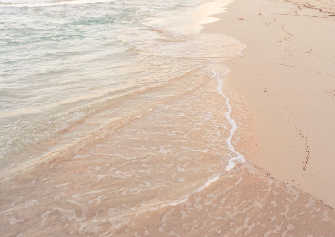 Soft Pastel Waves Lapping Pristine Pink Sand Shoreline at Golden Hour