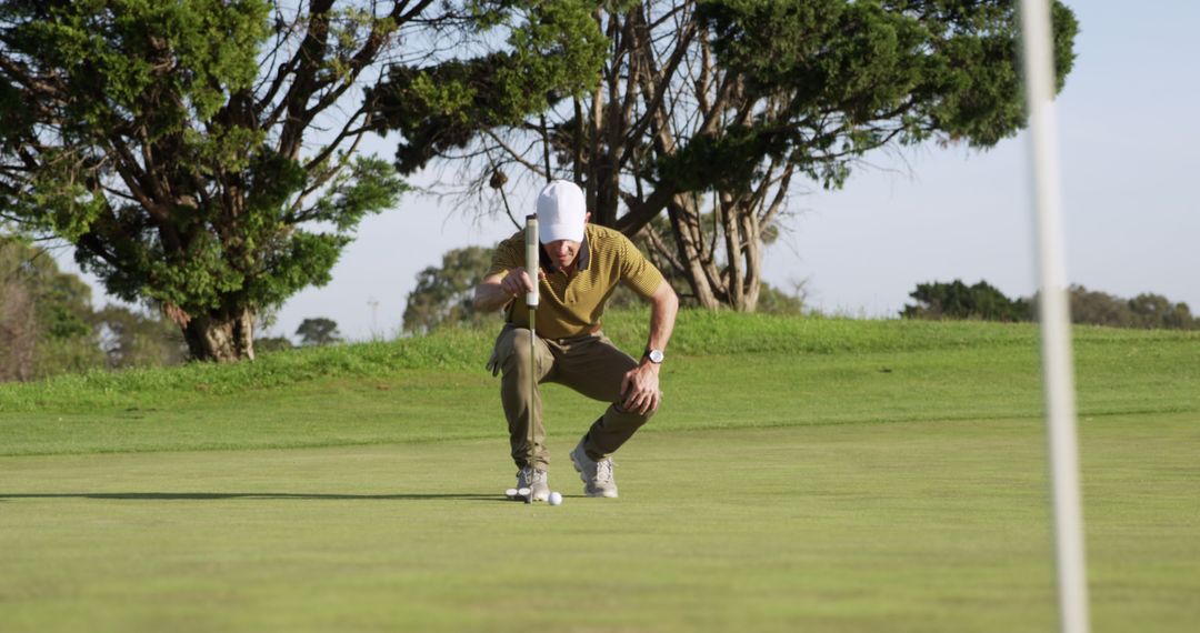 Golfer Analyzing Putt on a Bright Sunny Day