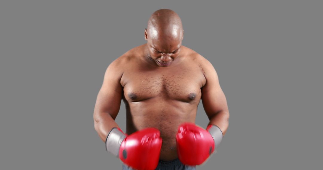 Determined Boxer Preparing for Fight with Red Gloves - Free Images, Stock Photos and Pictures on Pikwizard.com