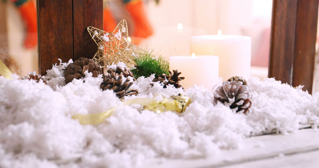 Cozy Winter Wonderland Candle Scene with Pinecones and Snow - Free Images, Stock Photos and Pictures on Pikwizard.com