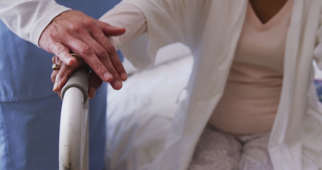 Nurse assisting senior woman with a walking frame