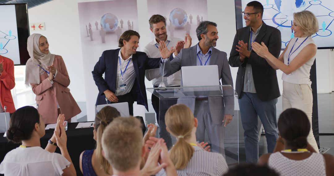 A biracial businessman receives applause on stage at a diverse business conference. - Free Images, Stock Photos and Pictures on Pikwizard.com