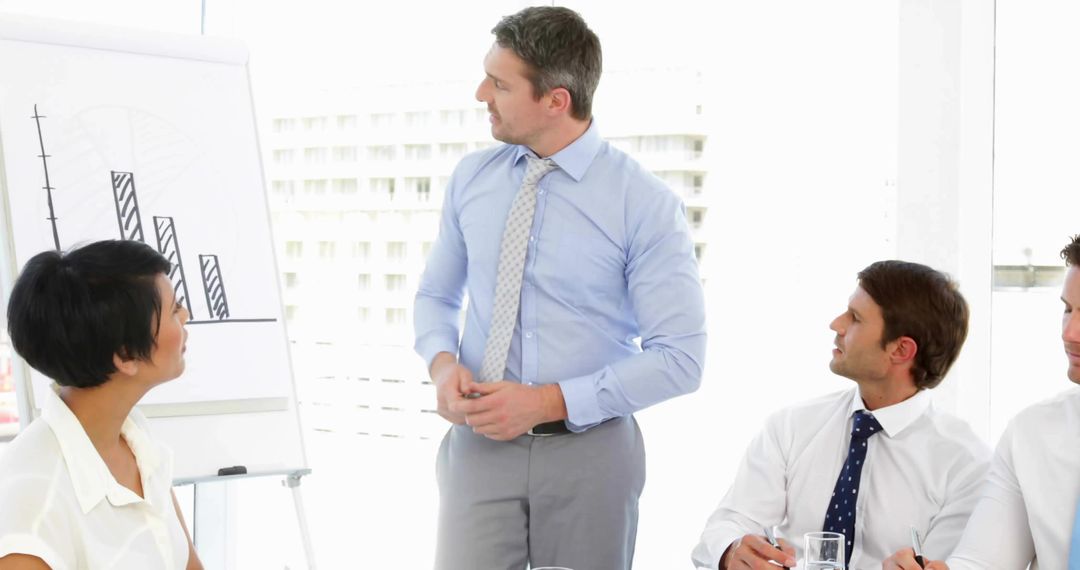 Business leader presenting quarterly results to team in bright modern office
