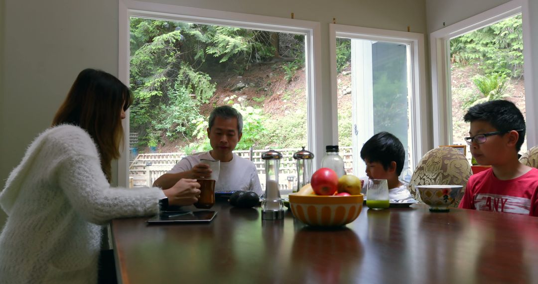 Family Having Breakfast Around Dining Table - Free Images, Stock Photos and Pictures on Pikwizard.com