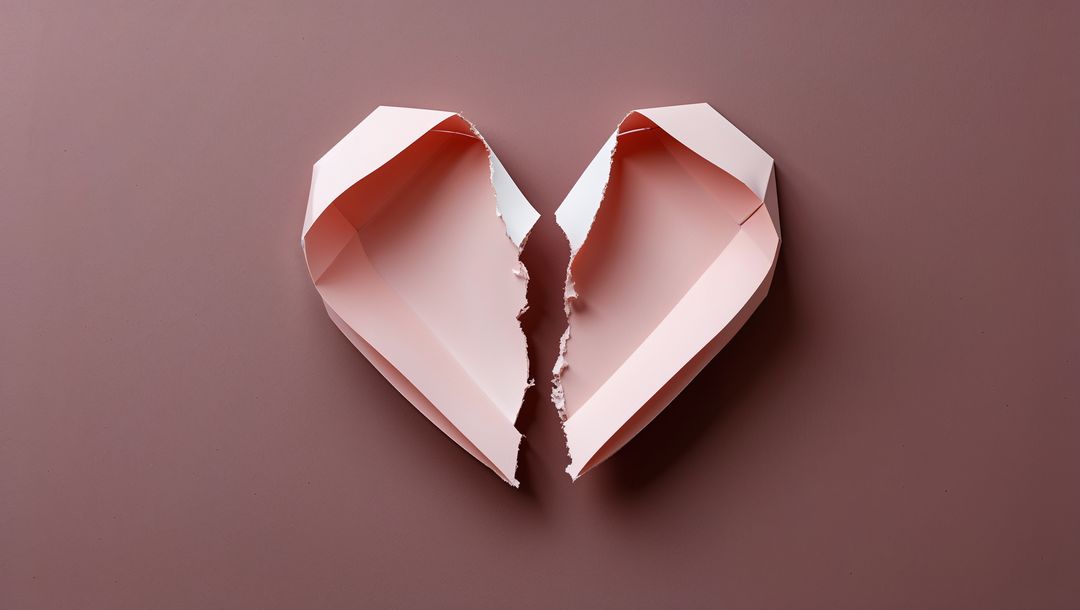 Broken Pink Paper Heart Symbolizing Vulnerability