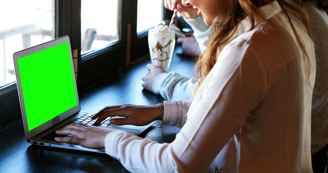 Woman Using Laptop With Green Screen in Coffee Shop - Free Images, Stock Photos and Pictures on Pikwizard.com