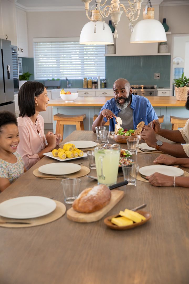Diverse Family Enjoying Meal at Home, Embracing Togetherness and Joyful Conversations