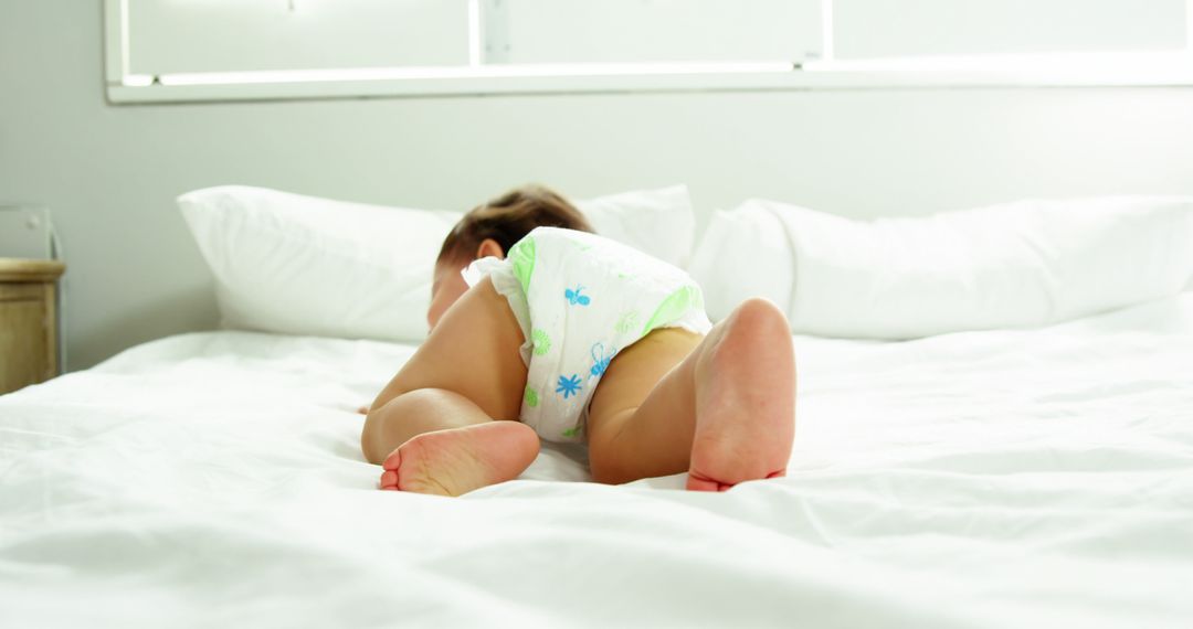 Baby Crawling Wearing Diaper on White Bed - Free Images, Stock Photos and Pictures on Pikwizard.com