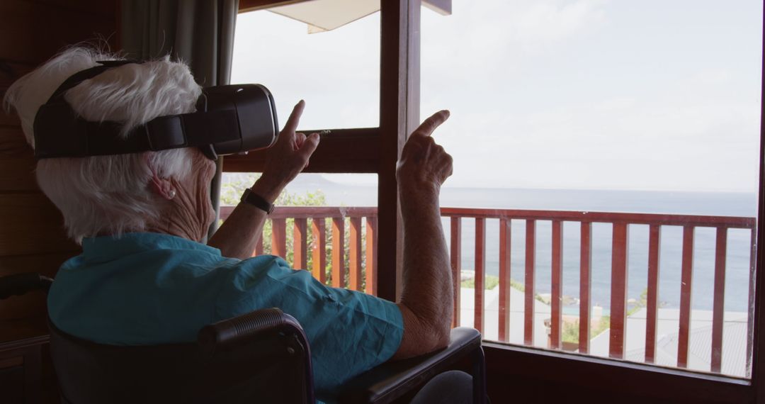 Elderly Woman in Wheelchair Using Virtual Reality at Seaside Home