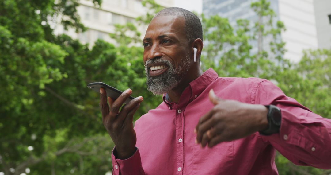 Businessman Using Voice Command on Smartphone Outdoors - Free Images, Stock Photos and Pictures on Pikwizard.com