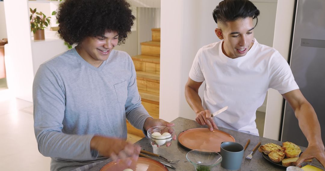 Diverse Friends Preparing Breakfast with Eggs and Toast at Kitchen Island