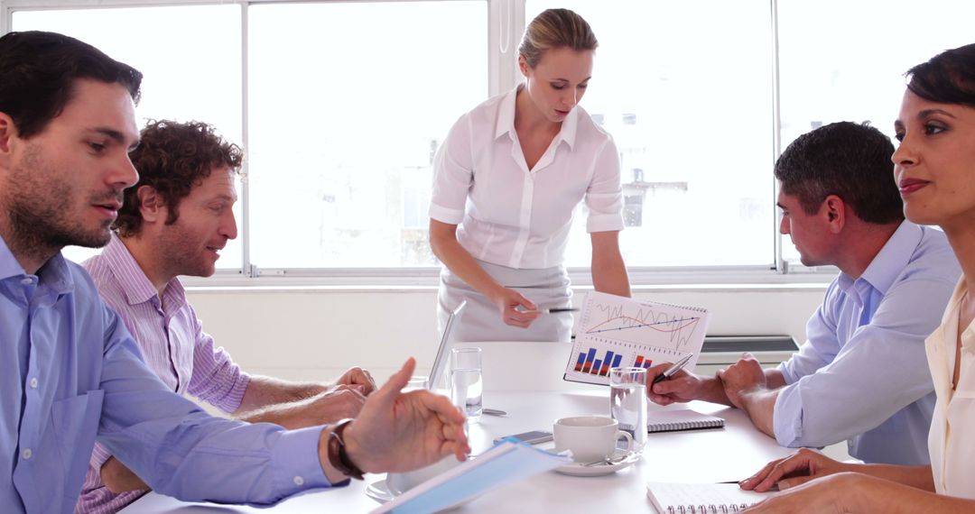 Team Collaborating at Office with Charts and Data Presentation