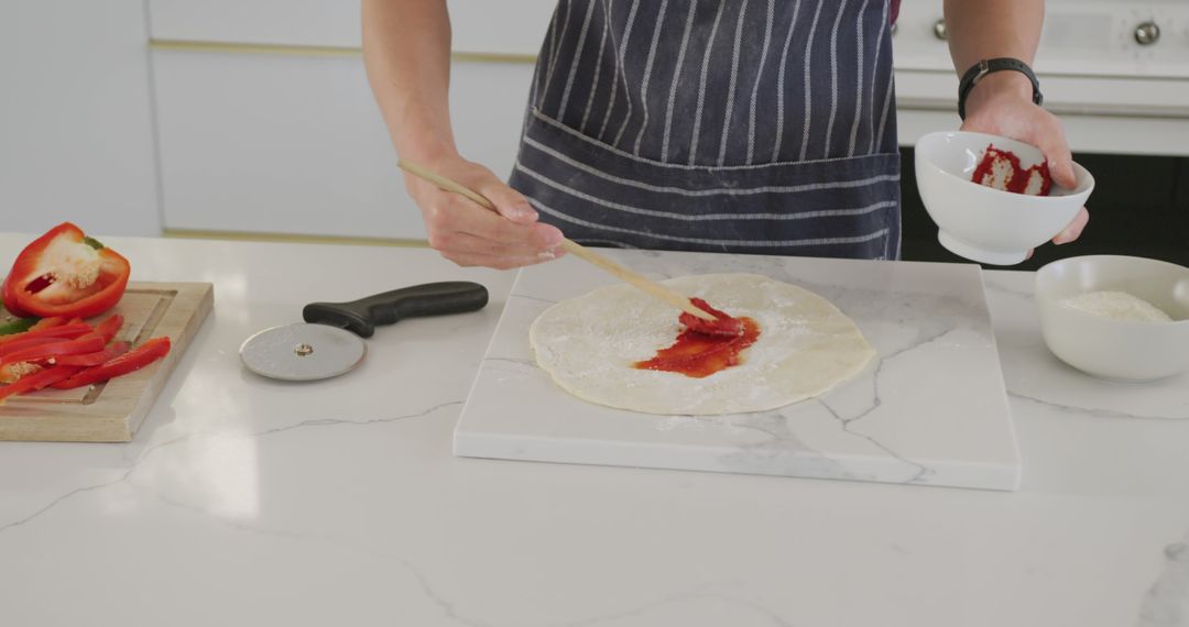 Person Preparing Homemade Pizza with Fresh Ingredients - Free Images, Stock Photos and Pictures on Pikwizard.com