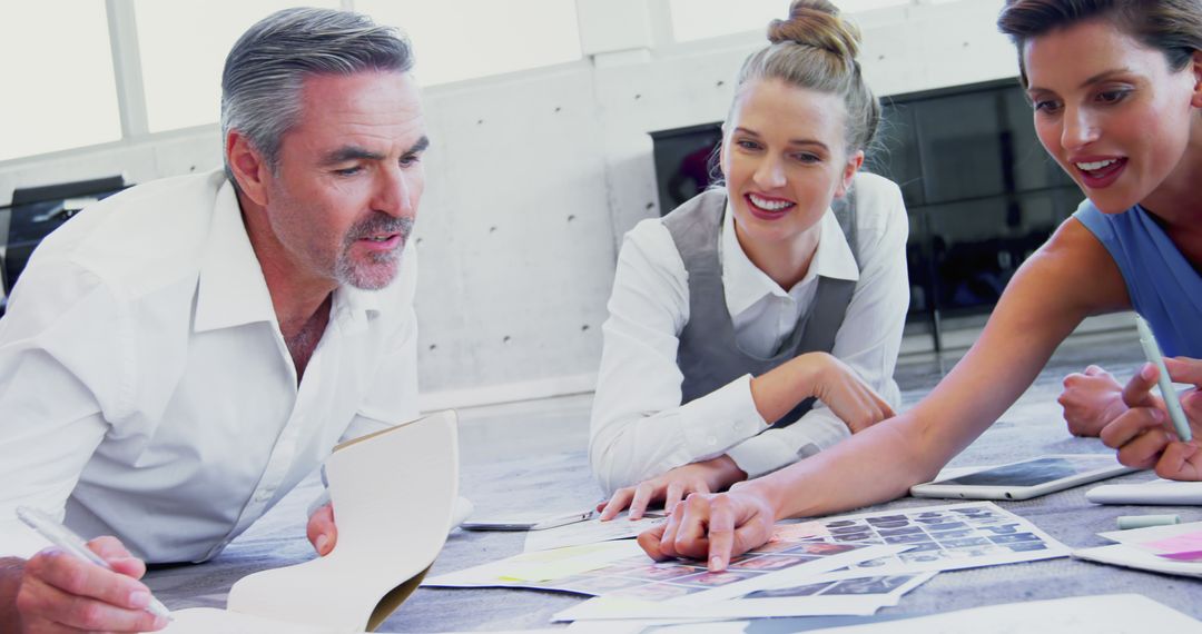 Collaborative Team Meeting with Documents and Color Samples