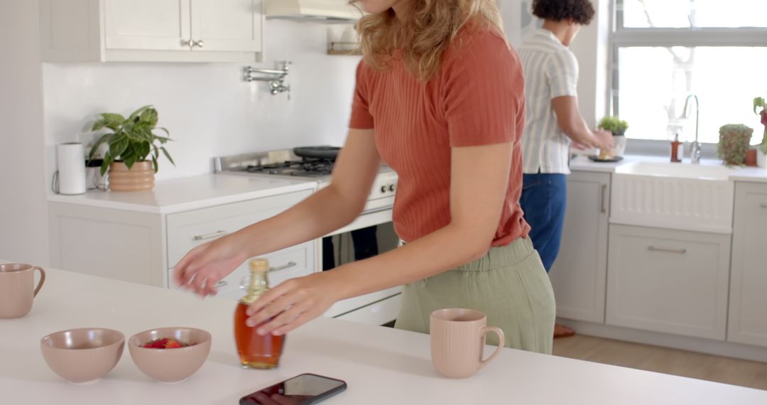 Diverse Couple Organizing Breakfast on Bright Kitchen Island