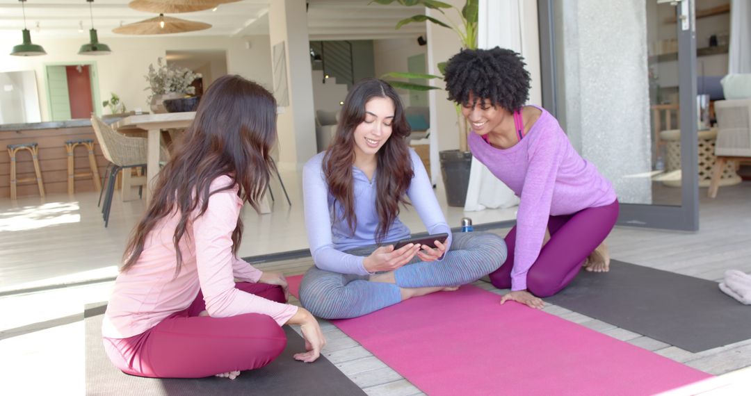 Diverse Female Friends Doing Yoga and Using Digital Tablet