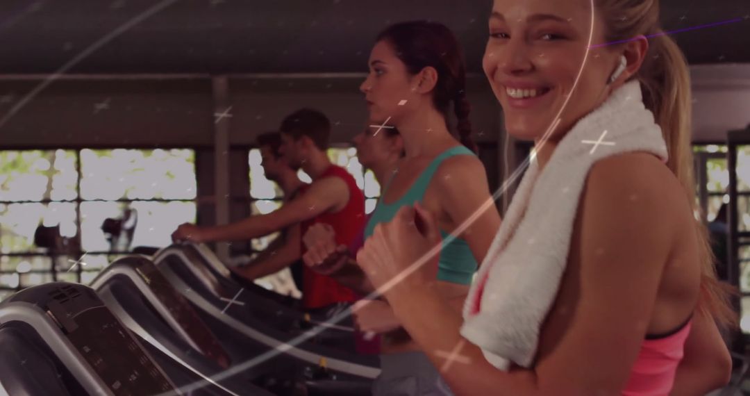 Group of Fit Individuals Exercising on Treadmills in Gym
