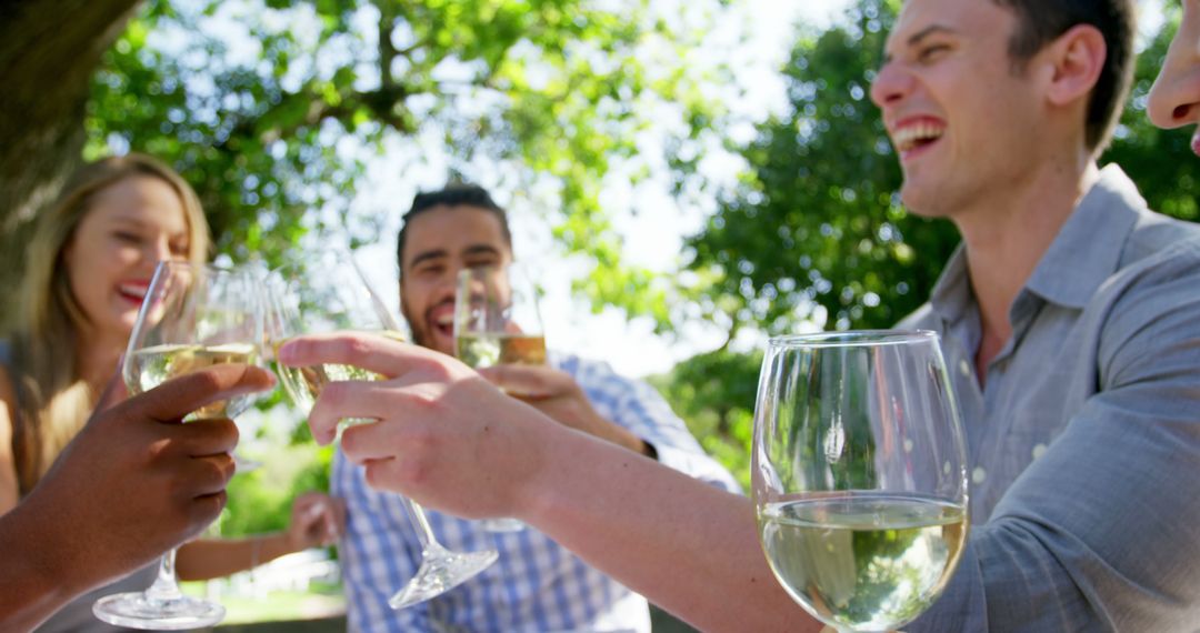 Friends Celebrating with Wine Outdoors under Trees - Free Images, Stock Photos and Pictures on Pikwizard.com