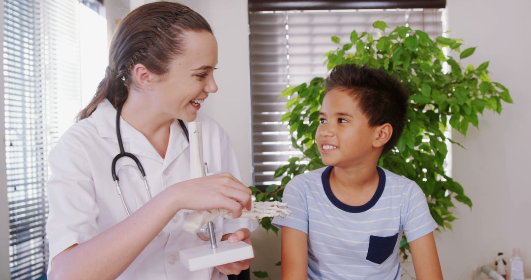 Smiling Pediatrician Showing Anatomical Model to Happy Child - Free Images, Stock Photos and Pictures on Pikwizard.com