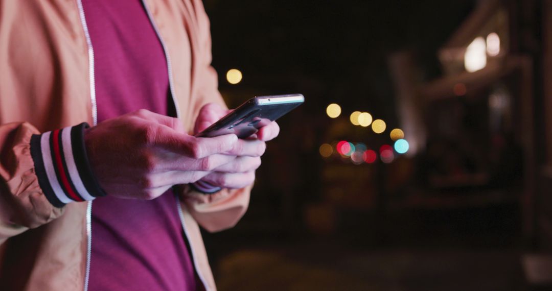 Man Texting on Smartphone at Night with Bokeh City Lights - Free Images, Stock Photos and Pictures on Pikwizard.com