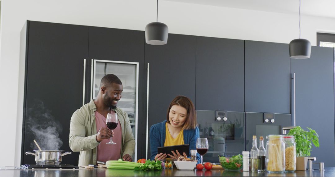 Diverse Couple Cooking Together and Toasting in Kitchen