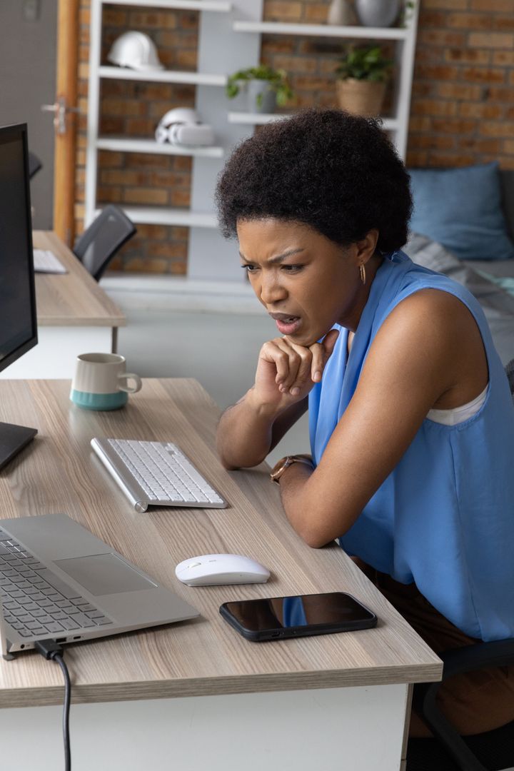 Professional Woman Focused on Completing Digital Task in Modern Office