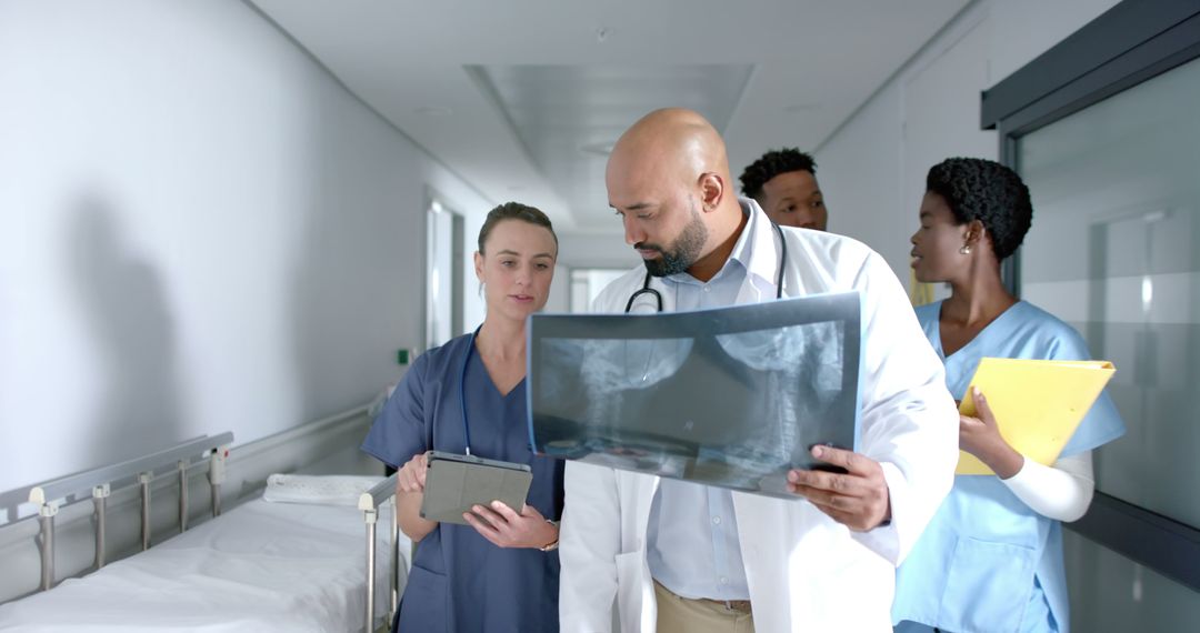 Medical Team Analyzing X-Ray in Busy Hospital Corridor - Free Images, Stock Photos and Pictures on Pikwizard.com