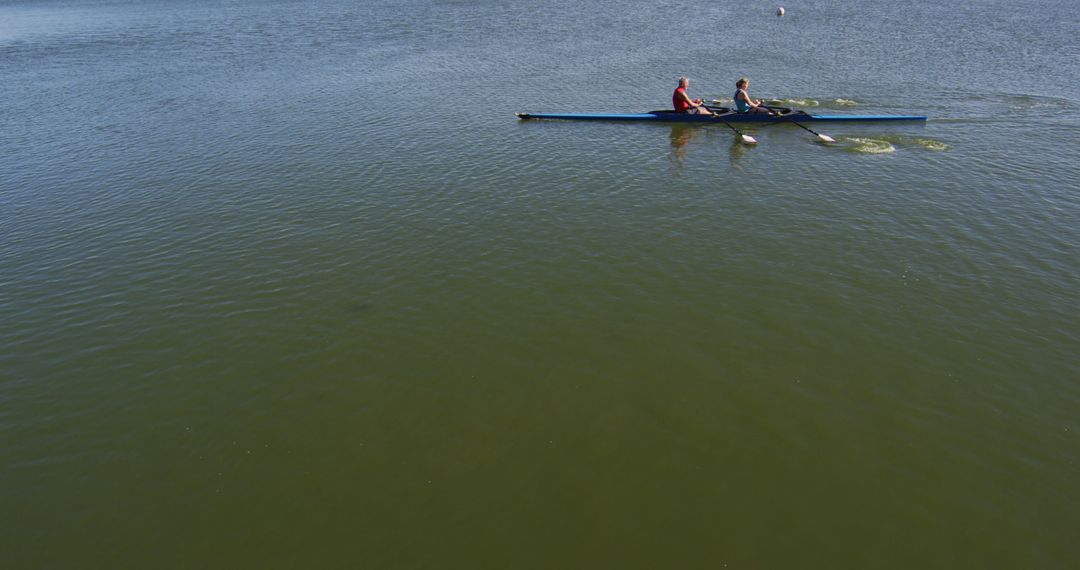 Senior caucasian man and woman rowing boat on a river - Free Images, Stock Photos and Pictures on Pikwizard.com