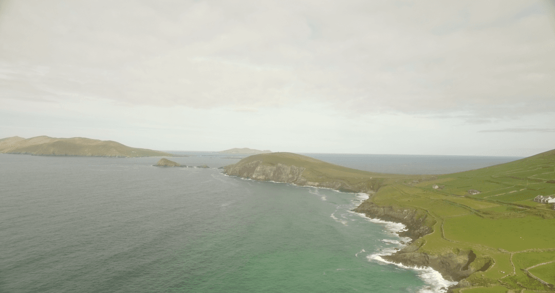 Spectacular Coastal Green Hills Under Transparent Clouded Sky